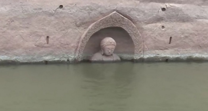 Eine alte Buddha-Statue tauchte plötzlich aus dem Wasser auf.